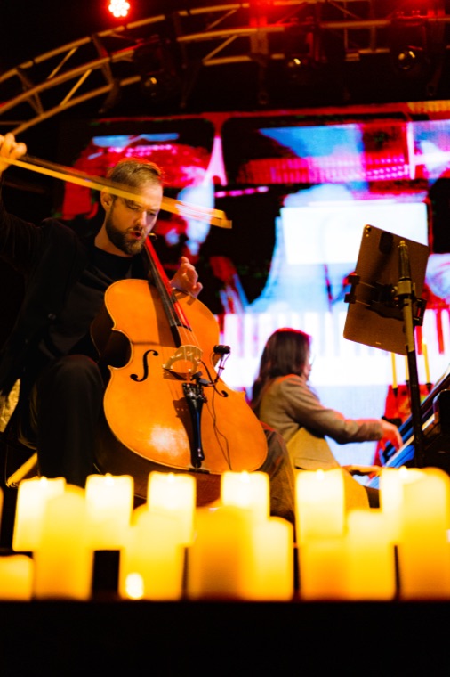 Cellist mid-stroke, bow in motion