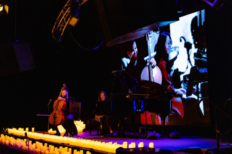 A moment between pieces on the candlelit stage