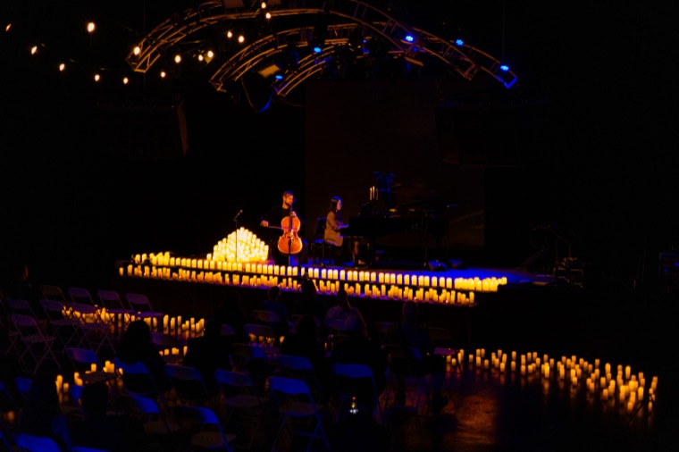 Wide view of the candlelit Lit Music stage during a performance